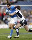 Italy centre Andrea Bacchetti  is tackled by the Scotland defence