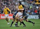 Danny Cipriani of Wasps is tackled by Willie Walker and Pat Sanderson of Worcester