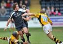 Alex Grove of Worcester passes the ball as Josh Lewsey of Wasps closes in.