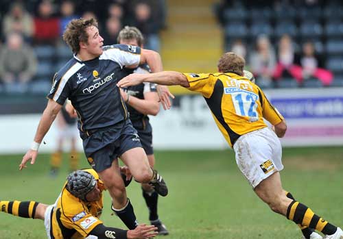 Alex Grove of Worcester passes the ball as Josh Lewsey of Wasps (R) goes to tackle during the Guinness Premiership match between Worcester Warriors and London Wasps at Sixways.