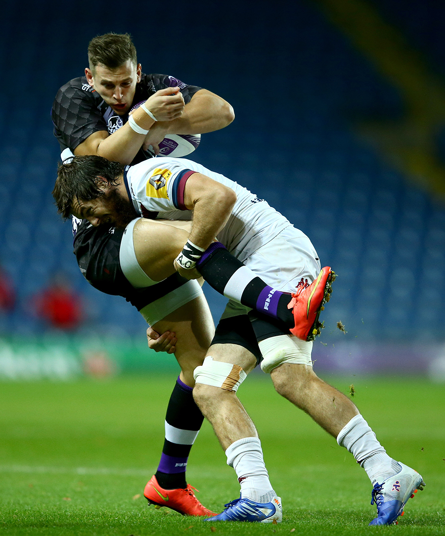 Nick Scott is tackled by Hugh Chalmers