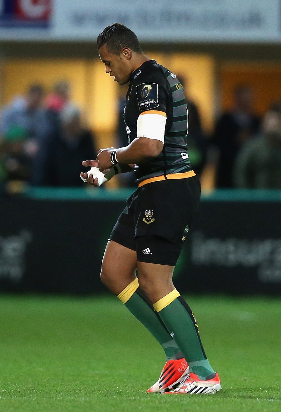 Northampton's Luther Burrell leaves the field with a hand injury.