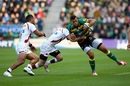 Luther Burrell holds off a Tom Brady challenge