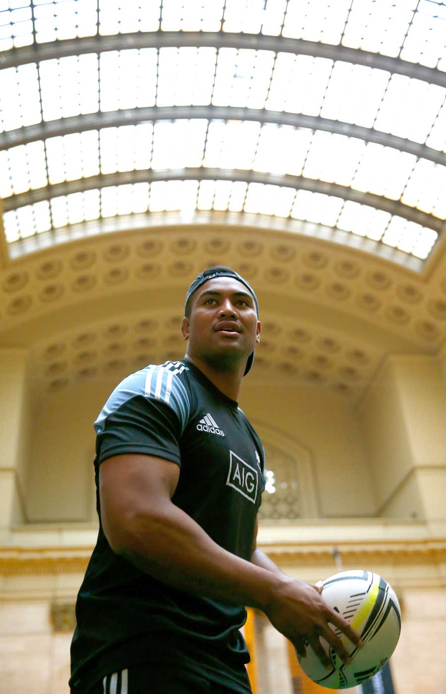 Julian Savea passes a rugby ball during a New Zealand All Blacks community skills session