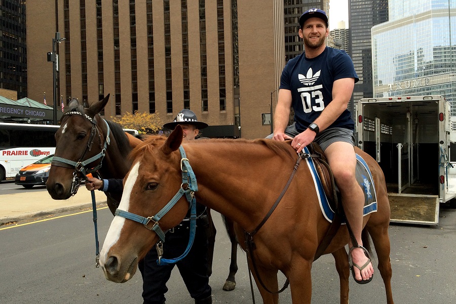 Kieran Read sits on a horse from the Chicago Police Department Mounted Patrol Unit