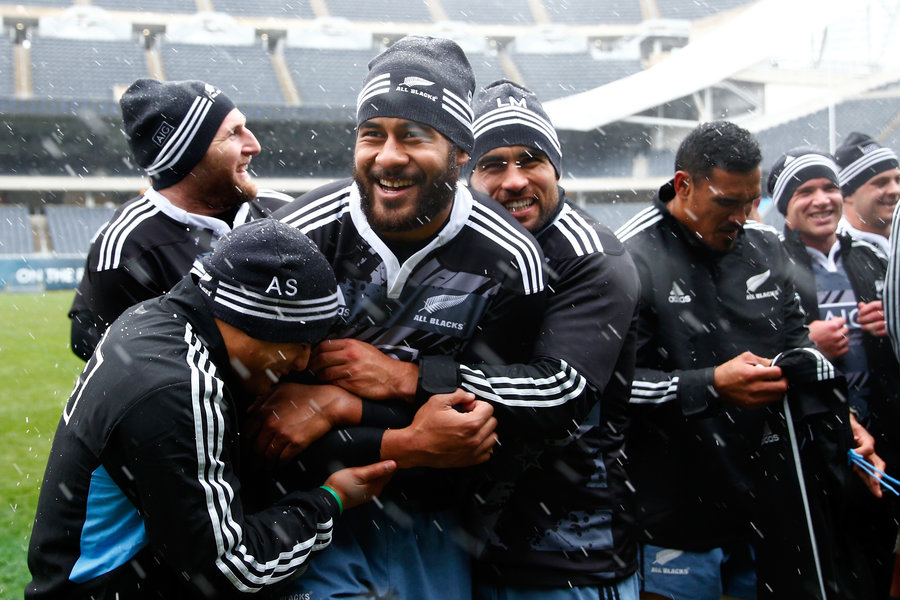Patrick Tuipulotu, Aaron Smith and Liam Messam attempt to stay warm in the freezing conditions during captain's run