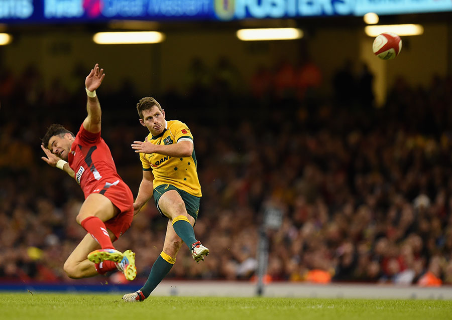 Bernard Foley kicks a drop goal to put Australia ahead in the closing stages, despite the attentions of Mike Phillips, Wales v Australia, Millennium Stadium, Cardiff, November 8, 2014