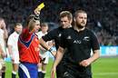 Nigel Owens of Wales issues a yellow card to New Zealand's Dane Coles