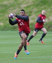 England's Kyle Eastmond takes a pass in training