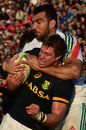 Jean de Villiers is wrapped up by Italy's Quintin Geldenhuys