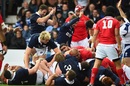 Blair Cowan scores for Scotland against Tonga amid a sea of bodies