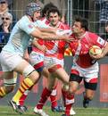 Montpellier's scrum-half Julien Tomas is tackled by Perpignan's Gerrie Britz 