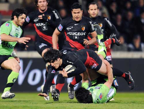 Toulouse centre David Skrela is tackled by Montauban's Regis Lespinas