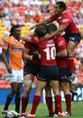 The Reds celebrate scoring a try against the Cheetahs