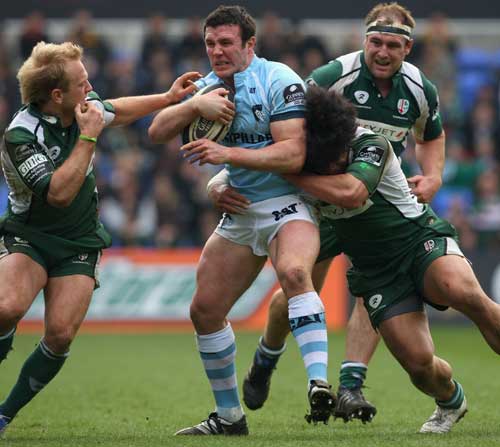 Leicester's Aaron Mauger works hard to protect the ball
