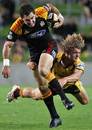 The Chiefs' Stephen Donald is tackled by the Western Force's Nick Cummins