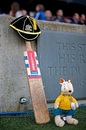 A cricket bat and Australian mascot Wally the Wallaby are placed by the Twickenham pitch in memory of cricketer Phillip Hughes 