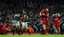 Wales celebrate their victory as the Springboks look on