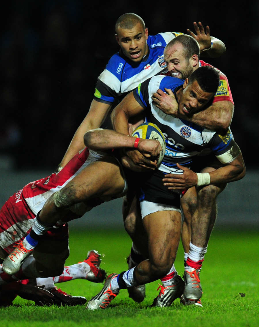 Bath's Anthony Watson is tackled by Charlie Sharples