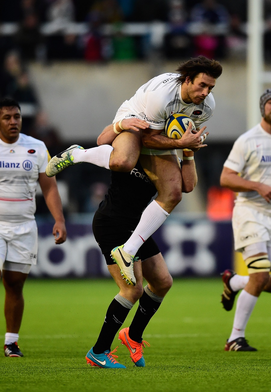 Alex Tait tackles Marcelo Bosch in the air 