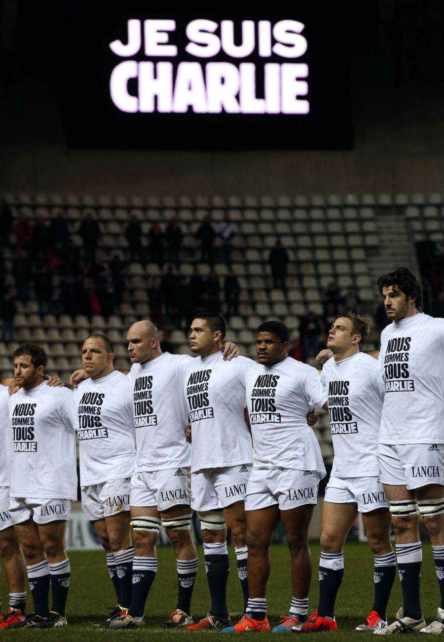 Stade Francais' players stand during a minute of silence 