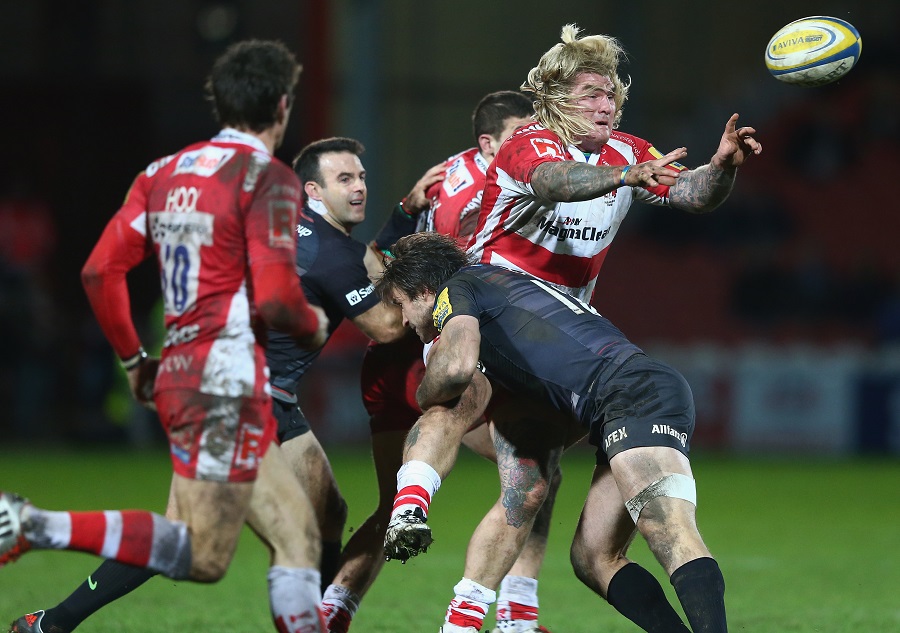 Gloucester's Richard Hibbard offloads as he is tackled by Saracens centre Marcelo Bosch