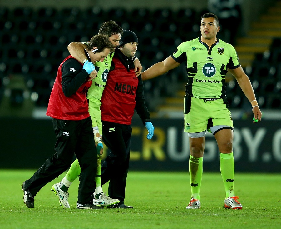 Northampton's Ben Foden is helped from the field with an injury