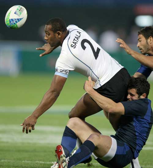 Fiji's Apo Satala is tackled by the France defence