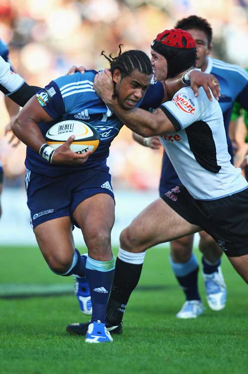 The Blues' Taniela Moa is tackled by the Sharks' Jacques Botes