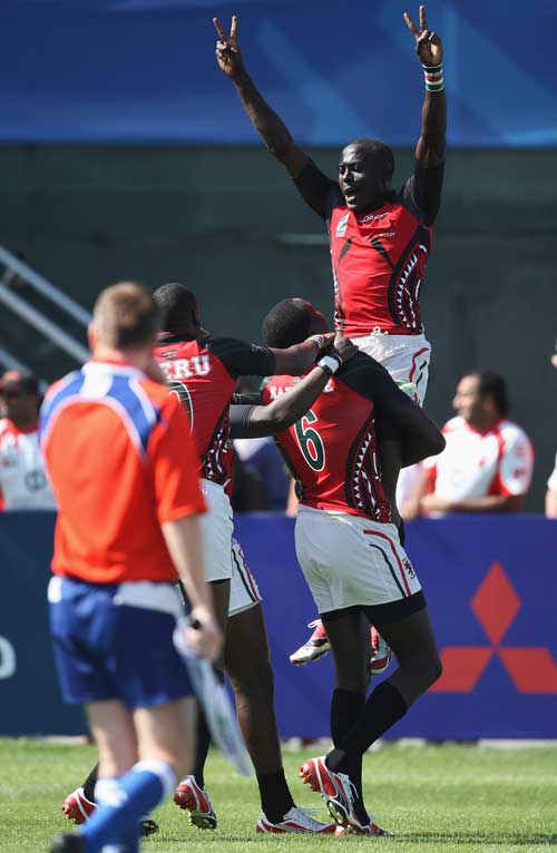 Kenya's Collins Injera is lifted into the air by team mate Humphrey Kayange