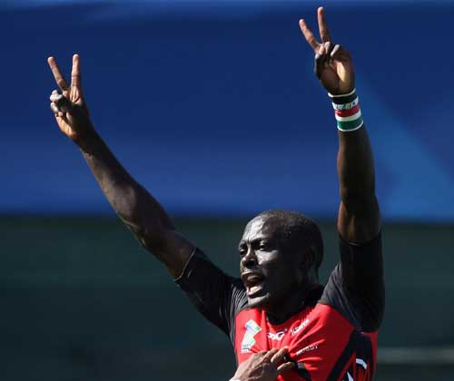 Kenya's Collins Injera celebrates scoring a try against Fiji