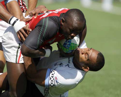 Fiji's Apolosi Satala fights for the ball with Kenya's Victor Oduor