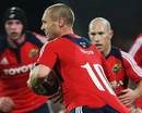 Munster's Paul Warwick stretches the New Zealand defence