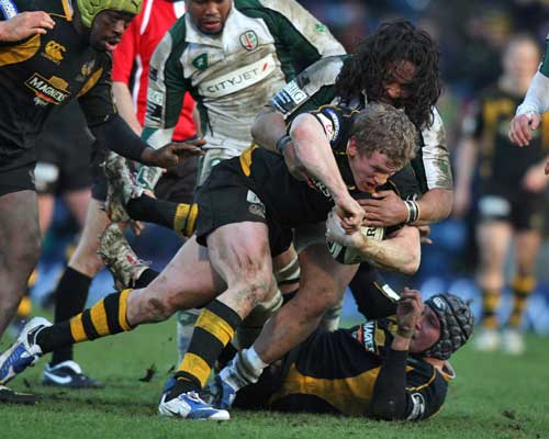 Wasps' Tom Rees is tackled by London Irish's Seilala Mapusua