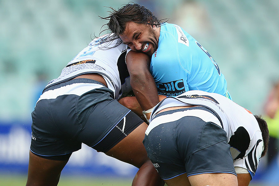 The Waratahs' Jacques Potgieter is tackled