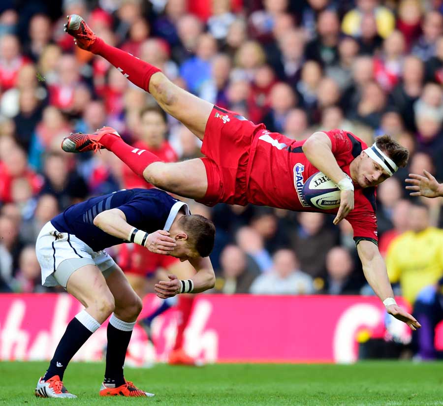 Scotland's Finn Russell catches Dan Biggar in the air