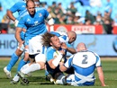 Josh Furno is tackled by Scotland defenders