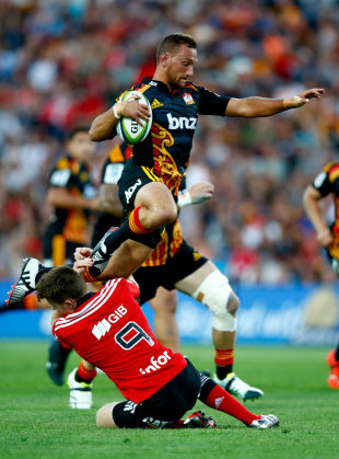Aaron Cruden of the Chiefs leaps over the tackle of Mitchell Drummond of the Crusaders, Chiefs v Crusaders, Super Rugby, Waikato Stadium, Hamilton, February 28, 2015