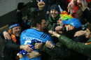 Edoardo Gori jumps into the crowd after Italy's win against Scotland