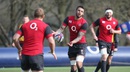 Courtney Lawes passes the ball during training with England