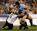 Waratahs fullback Sam Norton-Knight is tackled by the Brumbies' defence