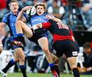 Western Force's James O'Connor is tackled by the Crusaders' Leon MacDonald