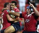 The Reds' Will Genia celebrates with his team mates after scoring a try