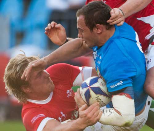 Italy skipper Sergio Parisse is tackled by Andy Powell