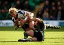Rudi Keil of Sale Sharks is tackled by Roger Wilson and James Downey of Northampton Saints