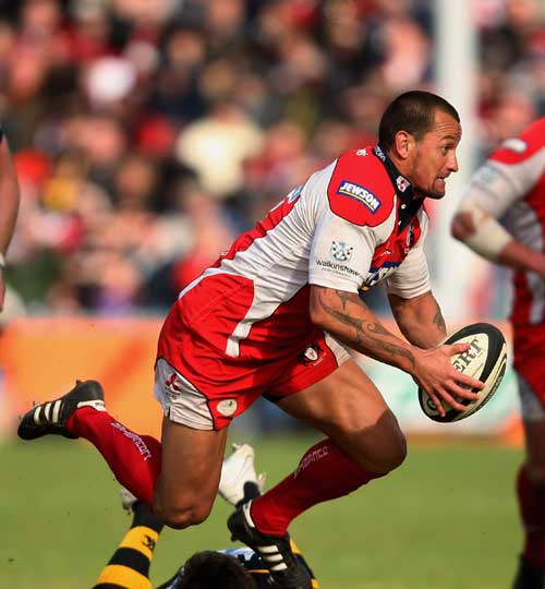 Carlos Spencer of Gloucester evades a tackle