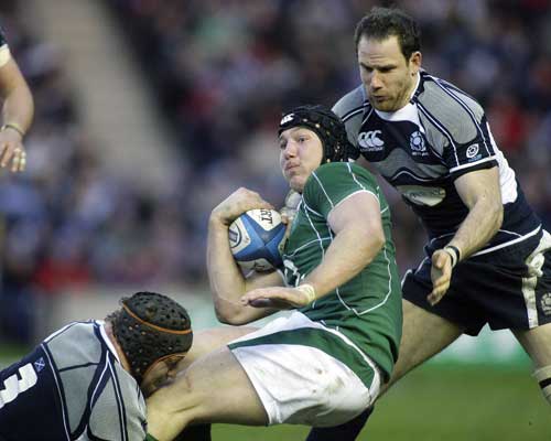 Ireland's Stephen Ferris is tackled by Scotland's Euan Murray and Graeme Morrison