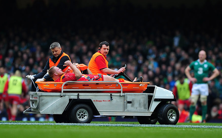Samson Lee is stretchered off with a leg injury