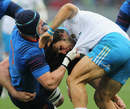 Giovanbattista Venditti of Italy is tackled by Bernard Le Roux
