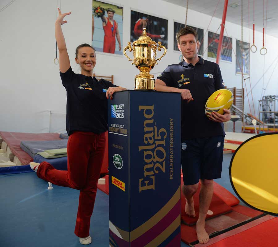 Gymnast Andreea Raducan poses alongside the Rugby World Cup with Ronan O'Gara